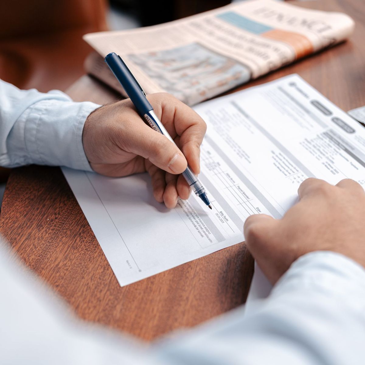 Person reviewing documents with pen